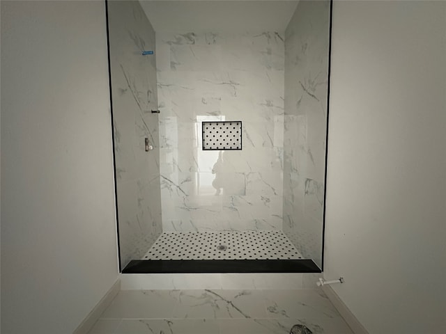 bathroom with tiled shower