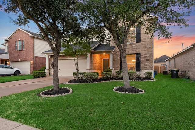 view of front facade with cooling unit, a lawn, and a garage