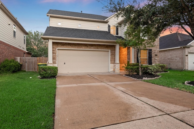 view of front facade with a yard and a garage