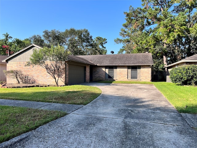 ranch-style home featuring a garage and a front lawn