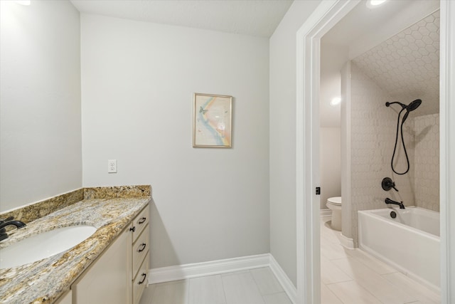 full bathroom featuring tiled shower / bath combo, vanity, toilet, and tile patterned floors