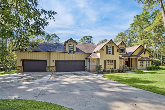 view of front of property featuring a garage and a front lawn