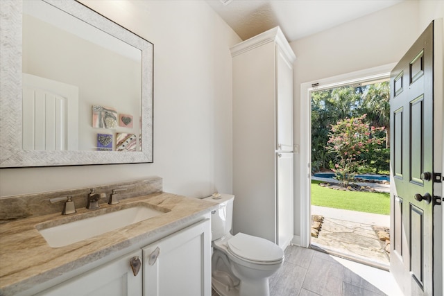 bathroom featuring toilet and vanity