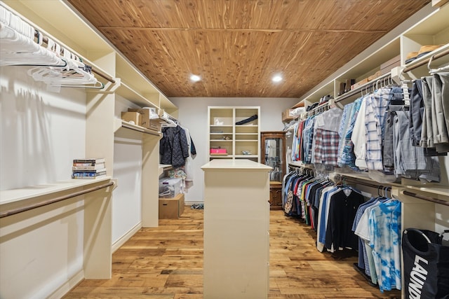 walk in closet with light hardwood / wood-style floors