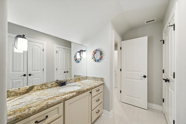 bathroom with tile patterned flooring and vanity