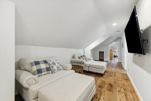 interior space with lofted ceiling and hardwood / wood-style flooring