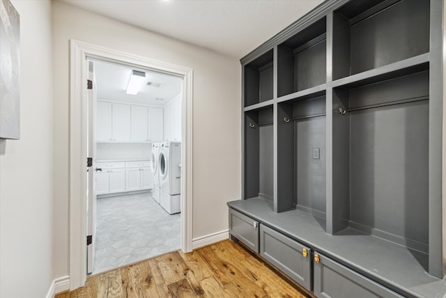 mudroom featuring separate washer and dryer and light wood-type flooring