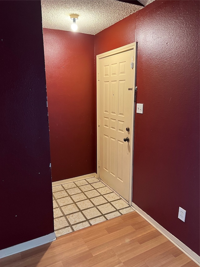 entrance foyer featuring a textured ceiling and wood-type flooring