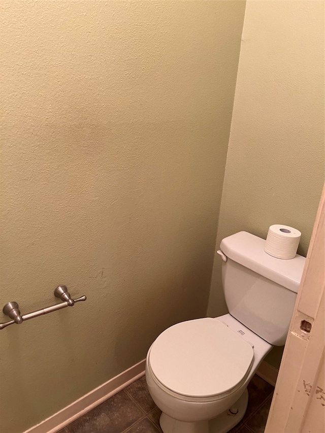 bathroom featuring toilet and tile patterned floors