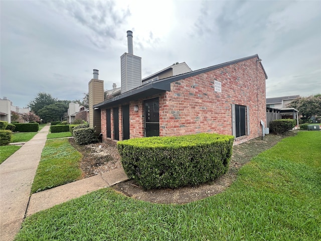 view of side of property with a lawn