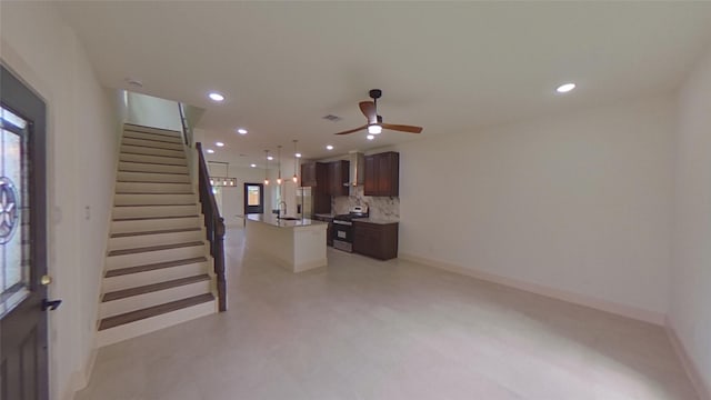 living room with ceiling fan and sink