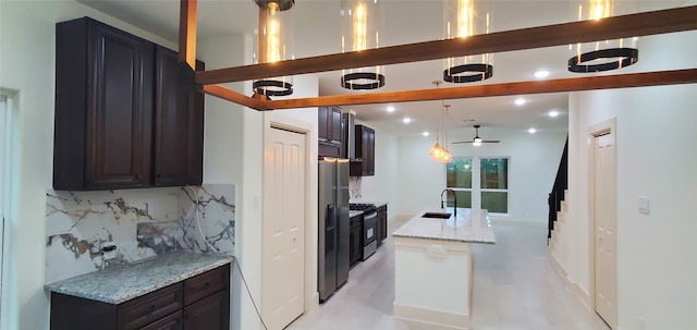 kitchen with ceiling fan, tasteful backsplash, light stone counters, decorative light fixtures, and stainless steel range with electric cooktop