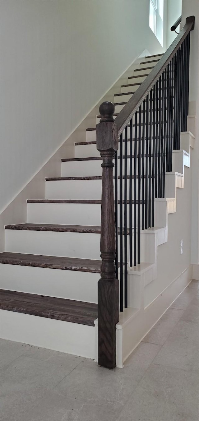 stairs with concrete flooring