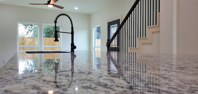 interior space with ceiling fan