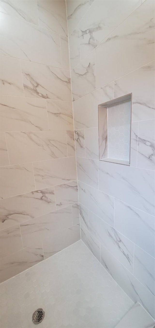 bathroom with a tile shower