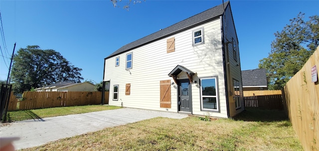 back of property with a lawn and a patio area