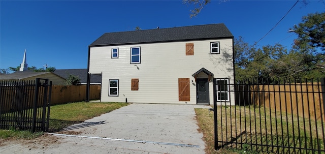 rear view of house with a yard