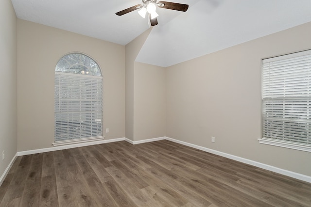 spare room featuring dark hardwood / wood-style flooring and ceiling fan