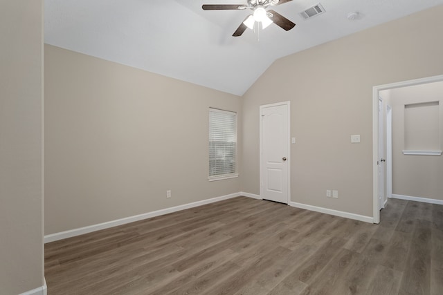 unfurnished bedroom with lofted ceiling, hardwood / wood-style floors, and ceiling fan