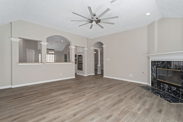 unfurnished living room featuring hardwood / wood-style floors, ceiling fan, a textured ceiling, and a premium fireplace