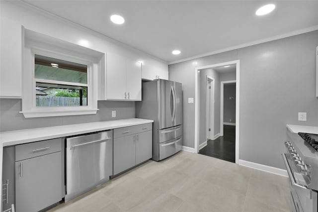 kitchen featuring stainless steel appliances, white cabinets, light countertops, and gray cabinets