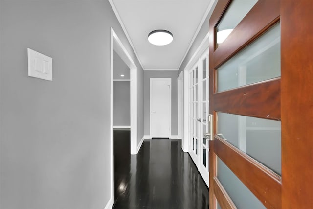 corridor featuring french doors, dark wood-type flooring, and ornamental molding