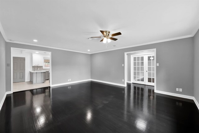 unfurnished living room with crown molding, baseboards, ceiling fan, and wood finished floors