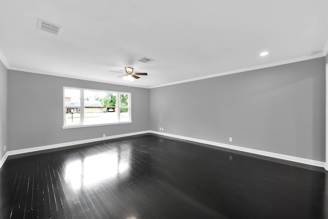 unfurnished room with ornamental molding, visible vents, baseboards, and wood finished floors