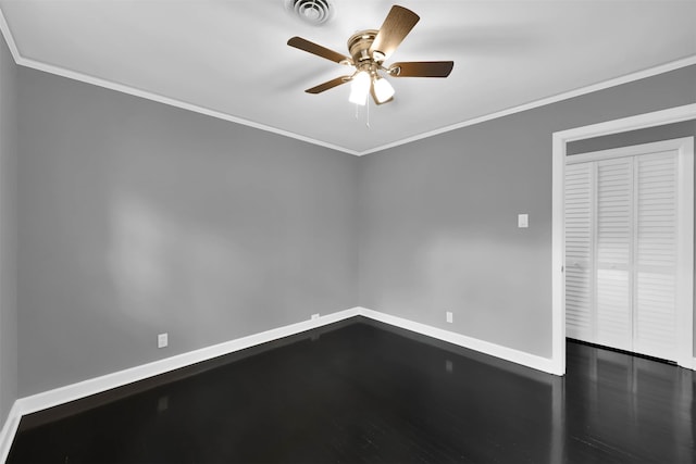 spare room featuring ornamental molding, visible vents, and baseboards