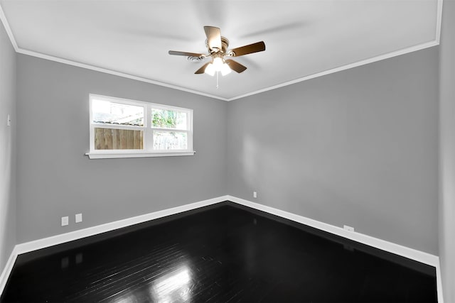 empty room with baseboards, ceiling fan, wood finished floors, and crown molding