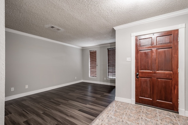 foyer with a textured ceiling, ornamental molding, and wood-type flooring