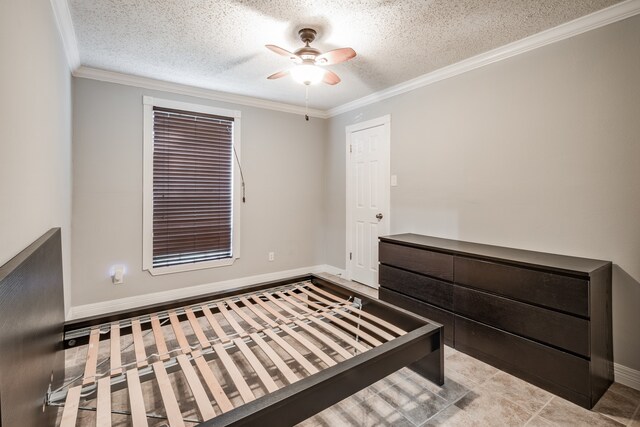 unfurnished bedroom featuring ceiling fan, crown molding, and a textured ceiling