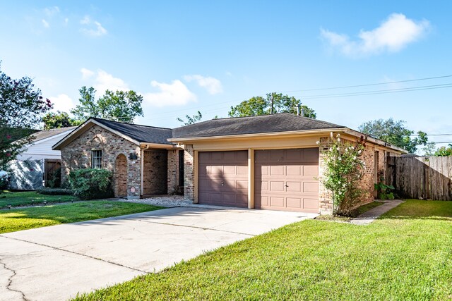 ranch-style house with a garage and a front lawn