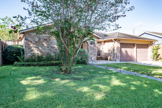 view of front of property featuring a garage and a front yard