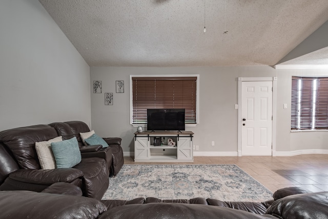 tiled living room featuring lofted ceiling and a textured ceiling