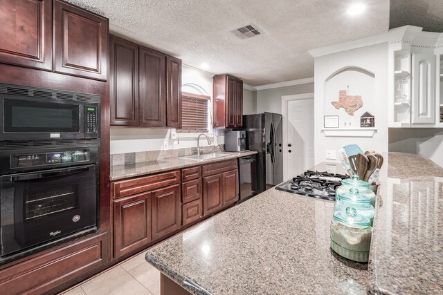 kitchen featuring crown molding, light tile patterned floors, black appliances, light stone counters, and sink