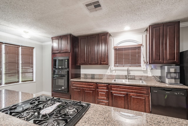 kitchen featuring crown molding, black appliances, a textured ceiling, and sink