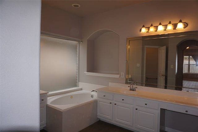 bathroom with vanity and a washtub