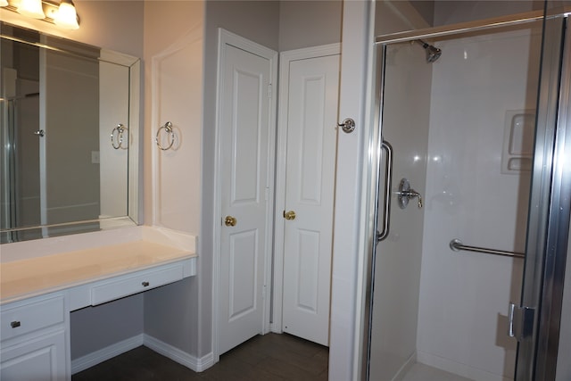 bathroom with vanity and a shower with shower door