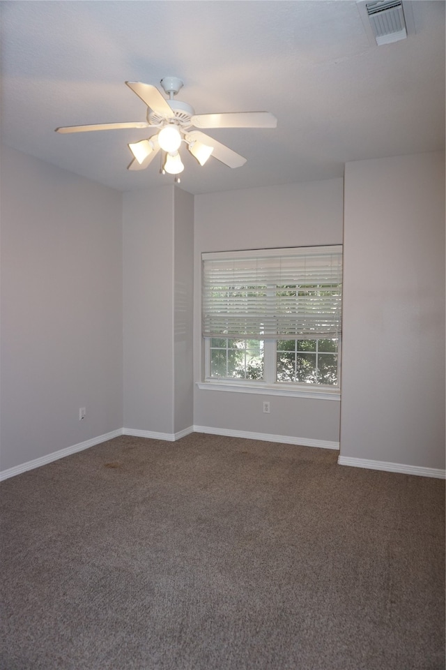 unfurnished room with ceiling fan and carpet