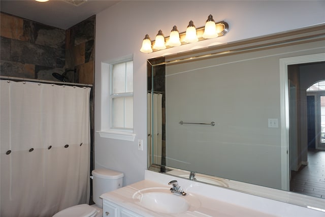 bathroom with hardwood / wood-style floors, vanity, toilet, and a shower with curtain