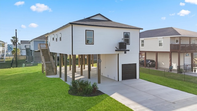 view of front facade with a garage, a front yard, and a carport