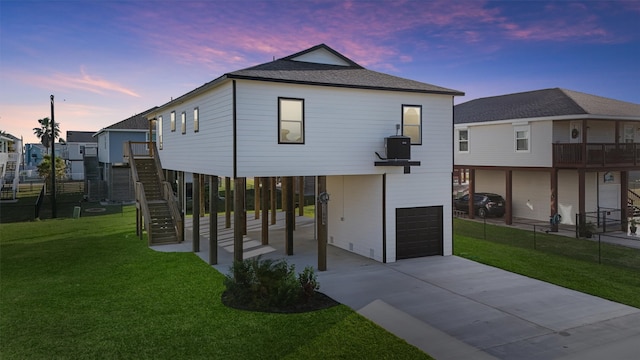 view of front of house featuring a garage and a lawn