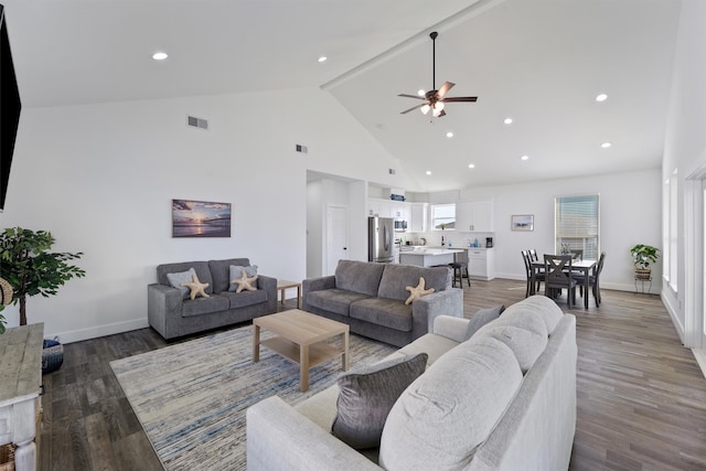 living room with hardwood / wood-style flooring, high vaulted ceiling, and ceiling fan