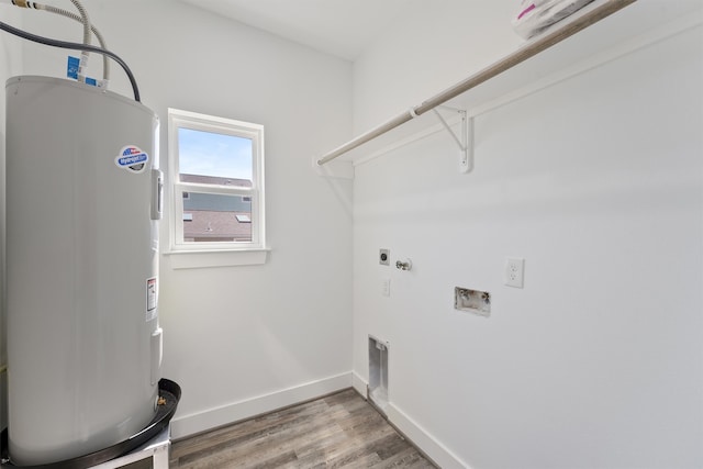 clothes washing area with electric water heater, hookup for a washing machine, hardwood / wood-style floors, and electric dryer hookup