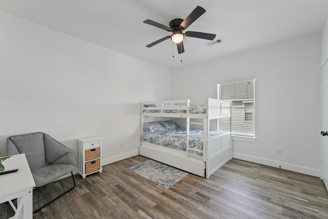 bedroom with ceiling fan and wood-type flooring