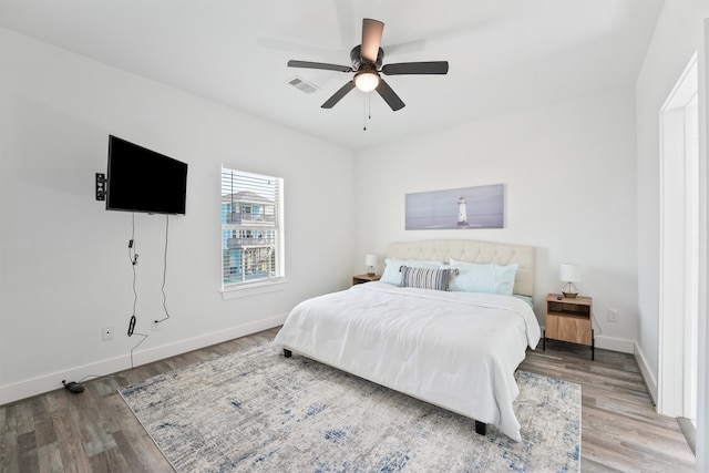 bedroom with ceiling fan and wood-type flooring