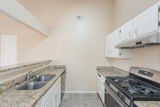 kitchen featuring white cabinetry, light tile patterned floors, stainless steel appliances, light stone counters, and sink