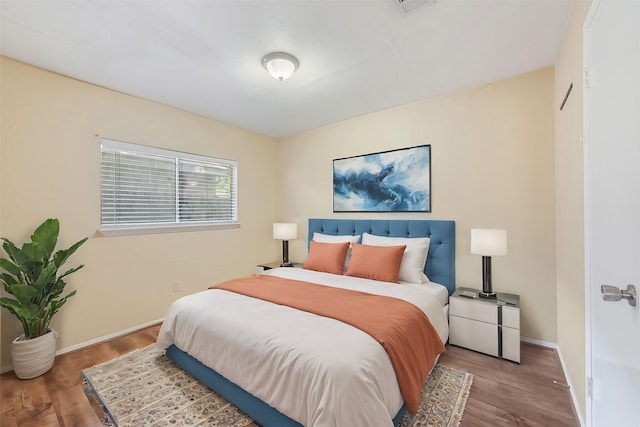 bedroom with wood-type flooring