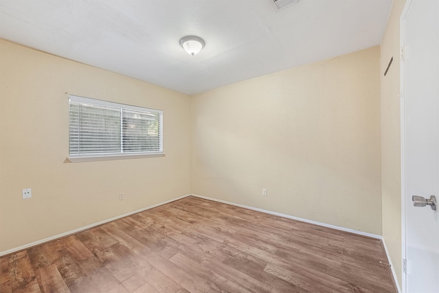 empty room with light hardwood / wood-style flooring